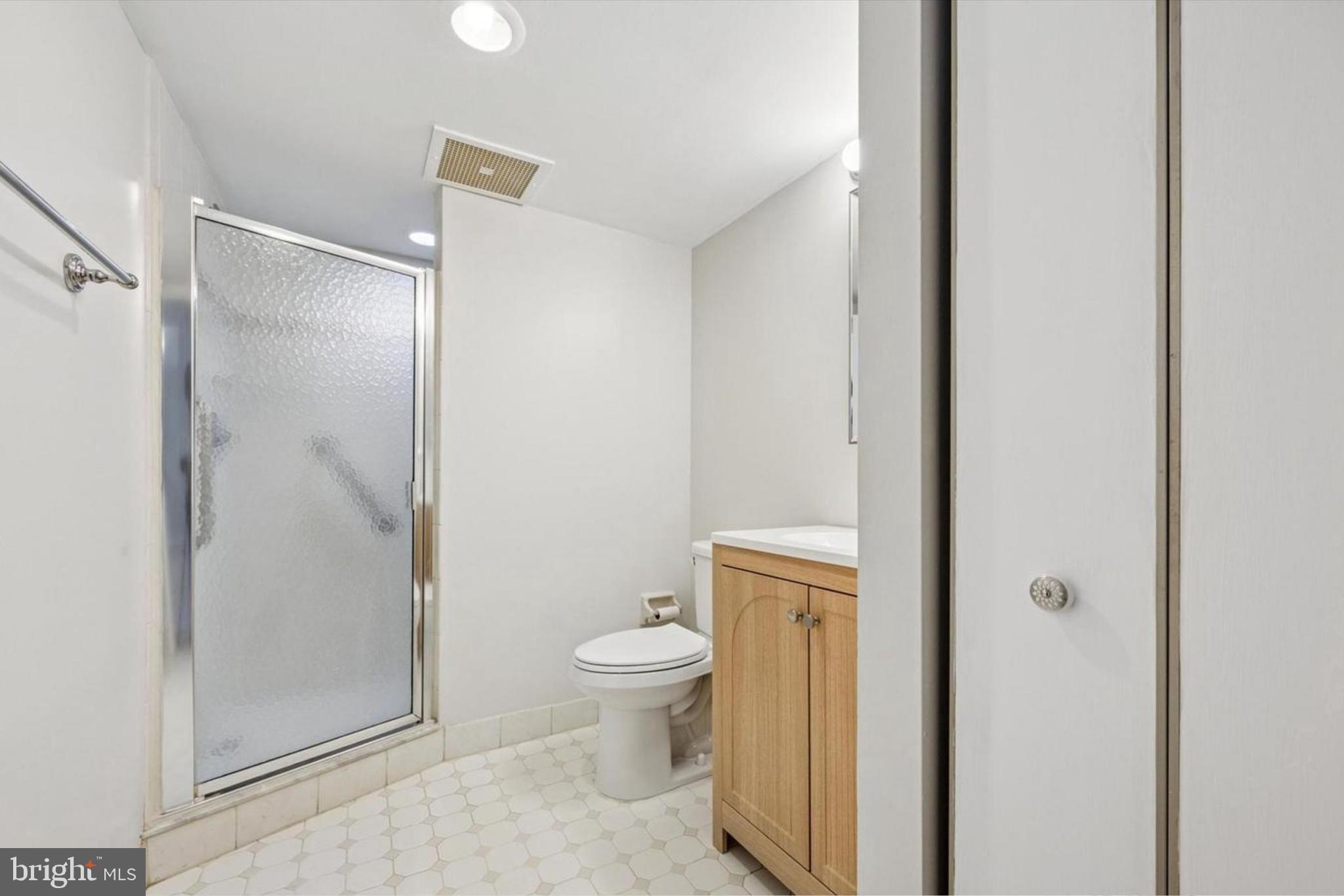800 Avondale Road, Unit 7B Wallingford, PA 19086 - Photo 13 of 24 a bathroom with a granite countertop toilet and a shower