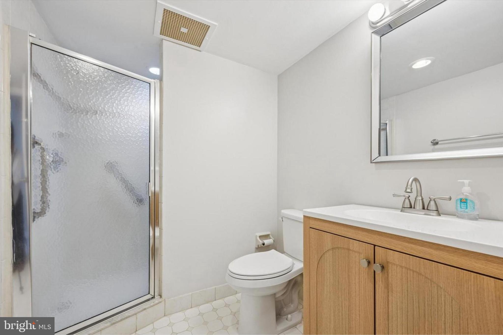 800 Avondale Road, Unit 7B Wallingford, PA 19086 - Photo 14 of 24 a bathroom with a sink a toilet and shower