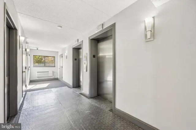 a view of a hallway with wooden shelves