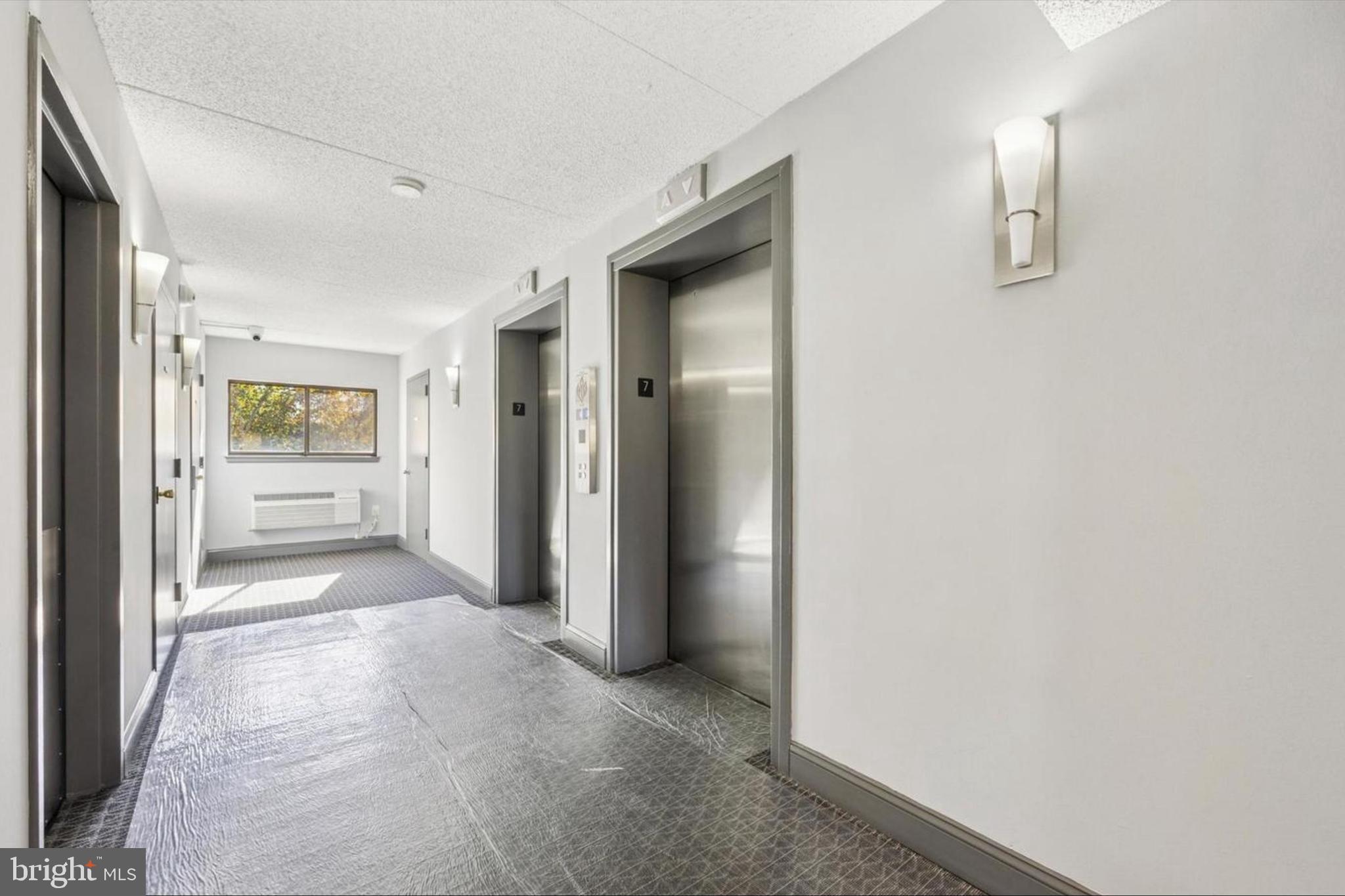 800 Avondale Road, Unit 7B Wallingford, PA 19086 - Photo 20 of 24 a view of a hallway with wooden shelves