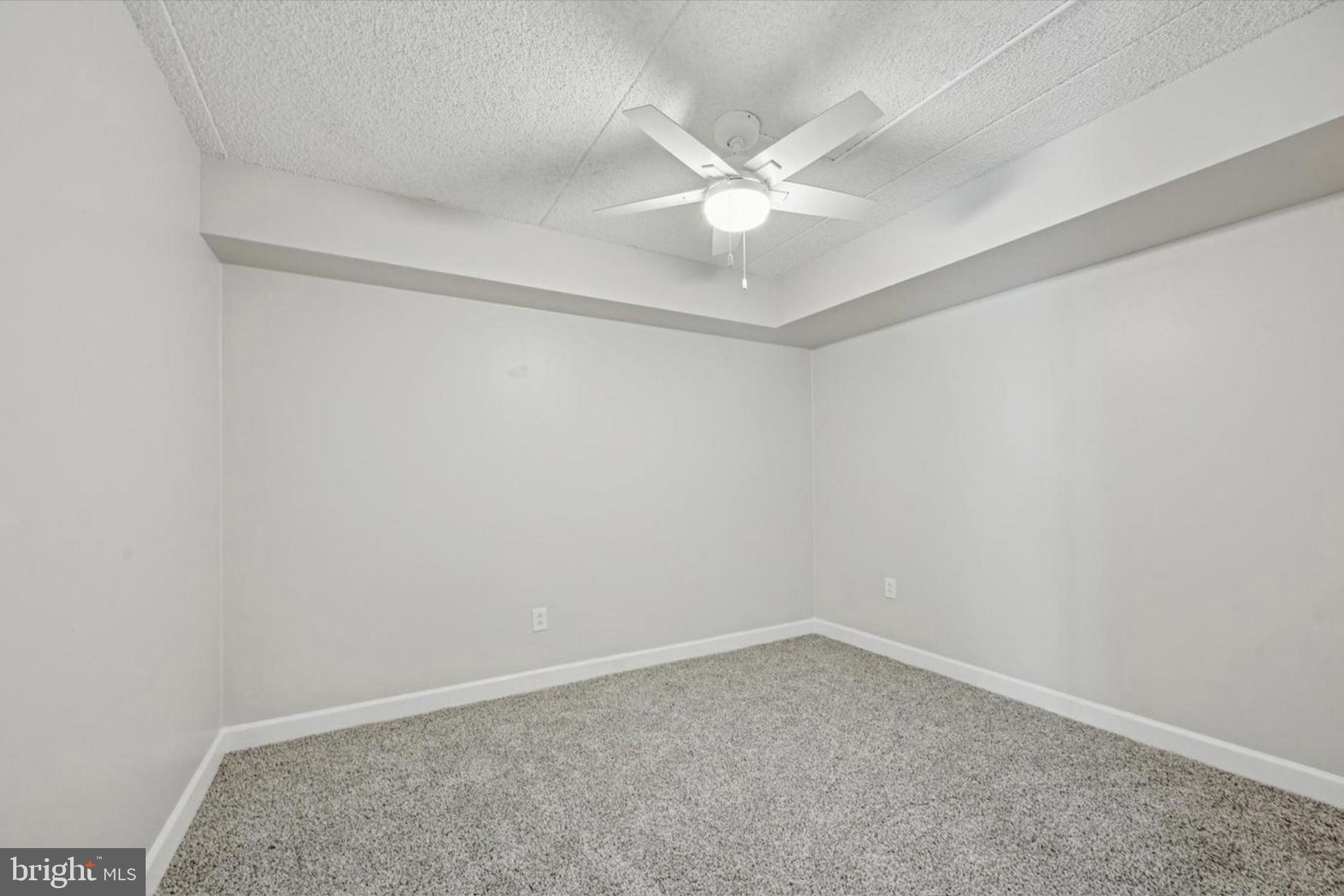 800 Avondale Road, Unit 7B Wallingford, PA 19086 - Photo 9 of 24 an empty room with a window and ceiling fan