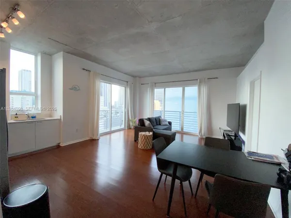 a view of a dining room with furniture and wooden floor