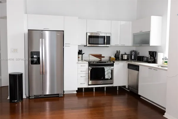 a kitchen with stainless steel appliances a refrigerator stove and microwave