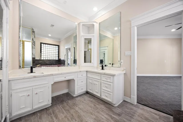 a large bathroom with a double vanity sink and mirror with shower