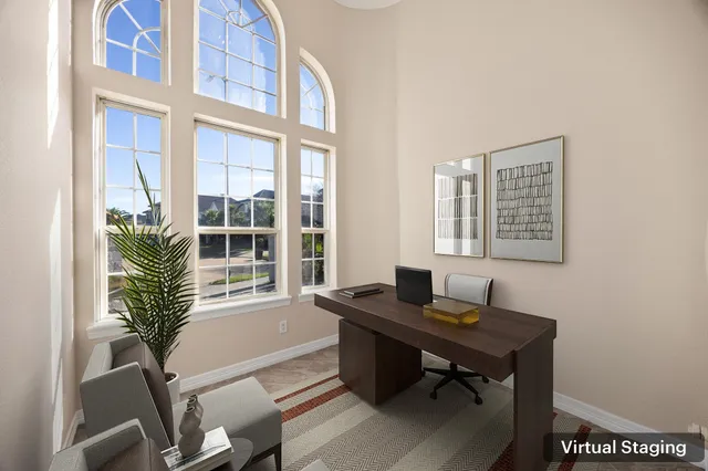 a view of a workspace with a window and wooden floor