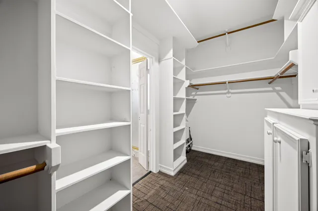 a view of walk in closet with empty racks