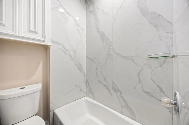 a bathroom with a bathtub and a toilet