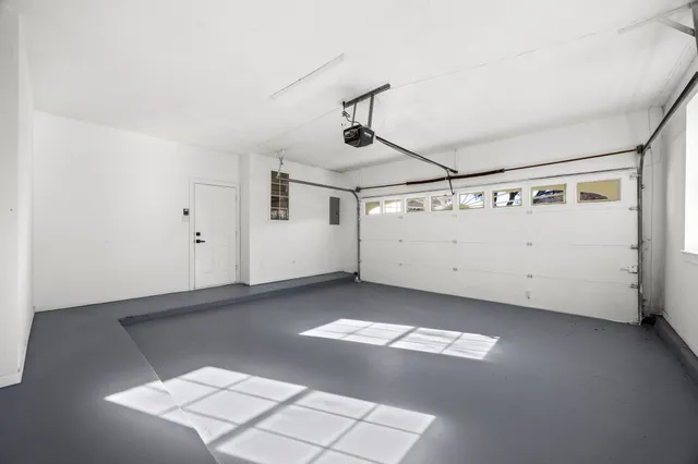 a picture of a room with a white wall and a window