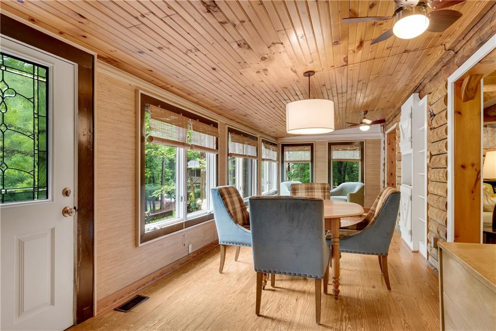 3582 Casteel Road Marietta, GA 30062 - Photo 15 of 55 a dining room with furniture a chandelier and wooden floor