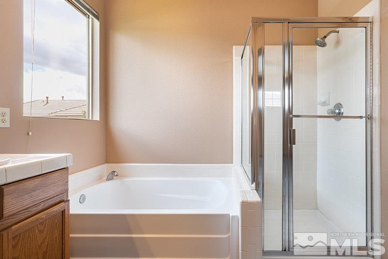 9716 Ripple Way Reno, NV 89521 - Photo 16 of 25 a bathroom with a bathtub and a shower