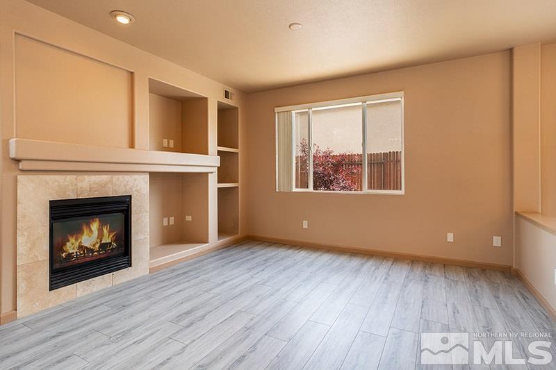 9716 Ripple Way Reno, NV 89521 - Photo 3 of 25 a view of an empty room with a fireplace and a window
