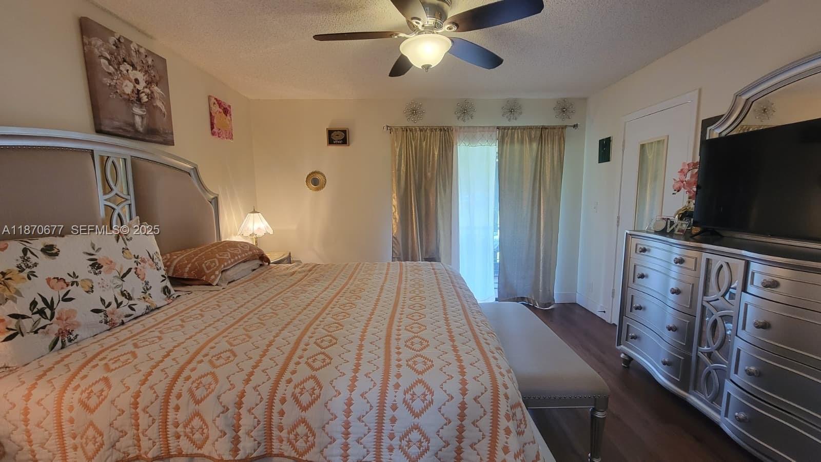 715 Banks Road Margate, FL 33063 - Photo 11 of 24 a bedroom with a bed and a flat tv screen on dresser