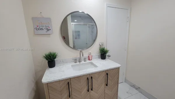 a bathroom with a granite countertop sink a toilet and a mirror