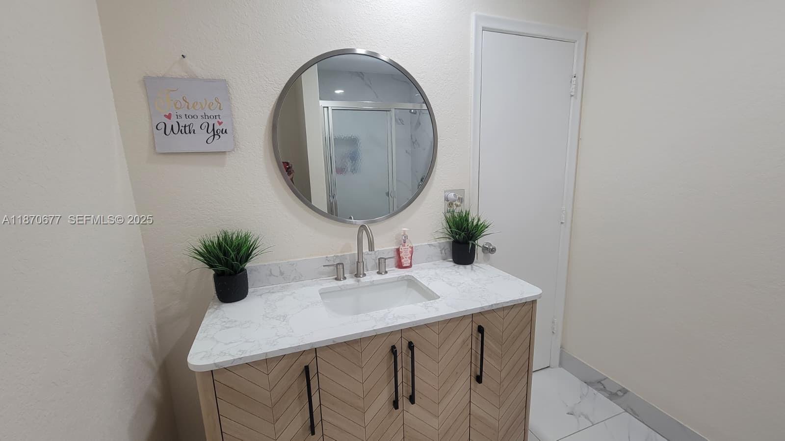 715 Banks Road Margate, FL 33063 - Photo 13 of 24 a bathroom with a sink and a mirror