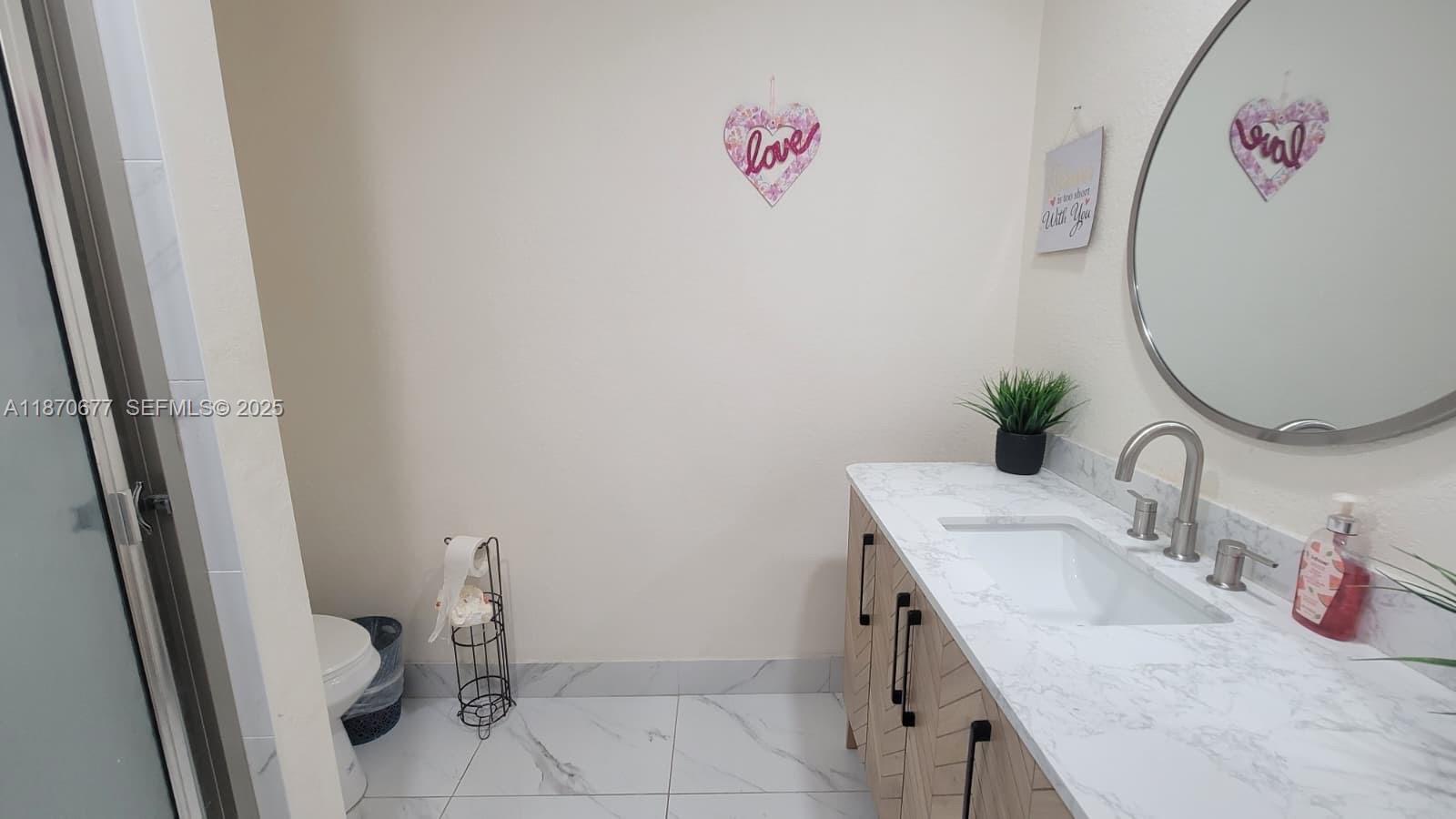 715 Banks Road Margate, FL 33063 - Photo 14 of 24 a bathroom with a granite countertop sink a toilet and a mirror