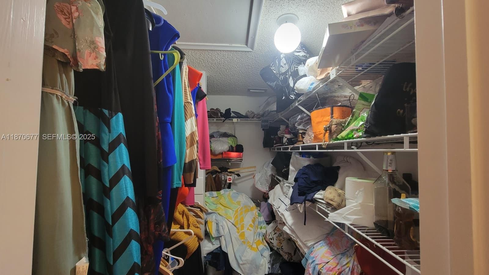 715 Banks Road Margate, FL 33063 - Photo 15 of 24 a view of walk in closet with clothes and shoes