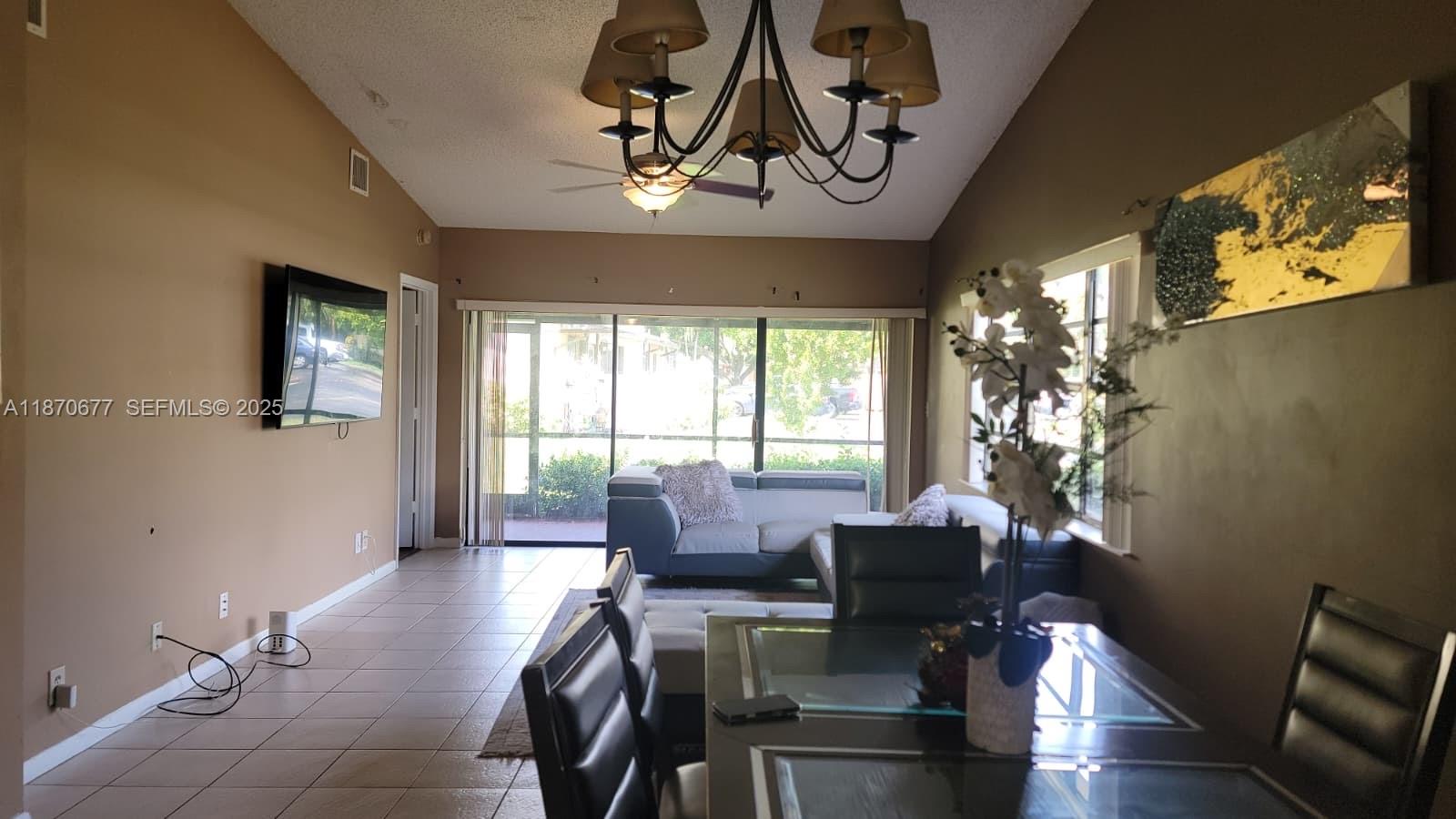 715 Banks Road Margate, FL 33063 - Photo 4 of 24 a view of a livingroom with furniture window and wooden floor