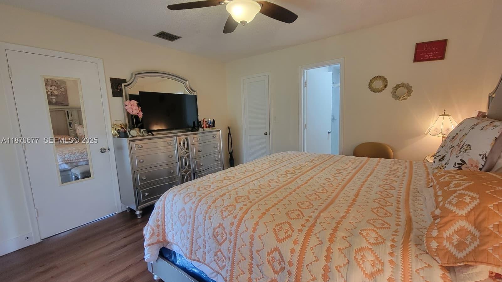 715 Banks Road Margate, FL 33063 - Photo 9 of 24 a bedroom with a bed and a flat screen tv