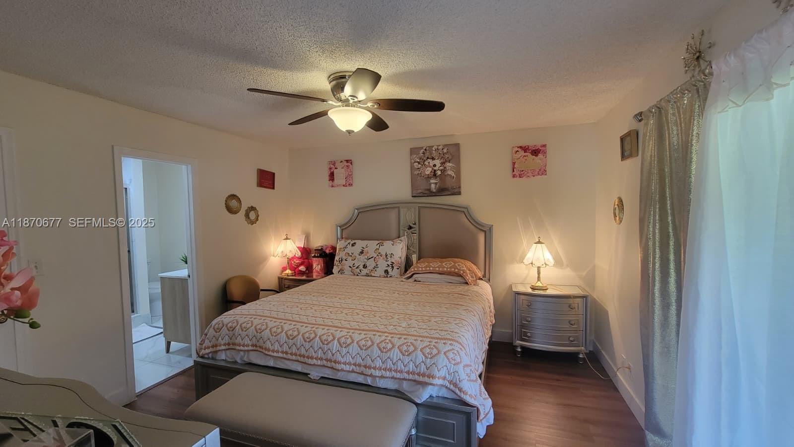 715 Banks Road Margate, FL 33063 - Photo 10 of 24 a bedroom with a bed and a chandelier