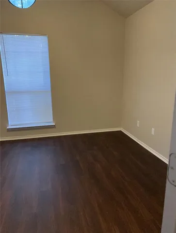 a view of room with wooden floor and cabinet