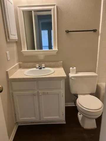 a bathroom with a toilet sink and mirror