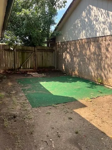 a backyard of a house with lots of green space