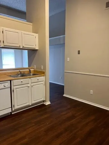 a view of cabinets and wooden floor