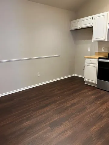 an empty room with wooden floor