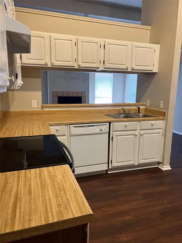 a kitchen with a wooden floor and a sink