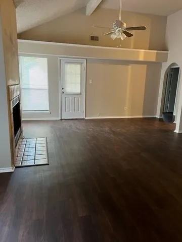 a view of a livingroom with wooden floor and a cabinet