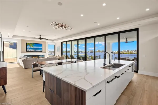 a large white kitchen with a large window