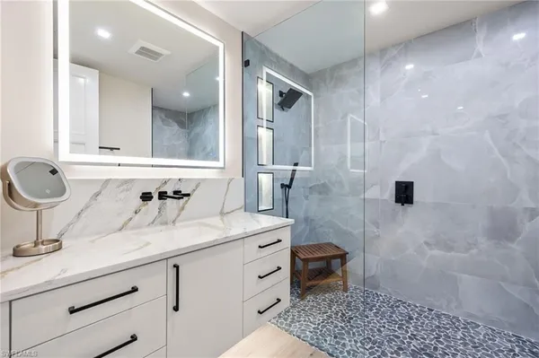 a bathroom with a sink a toilet and a shower