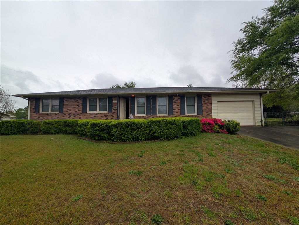 1000 Hickory Lane Anderson, SC 29624 - Photo 1 of 37 This charming residence offers a classic brick exterior, inviting landscaping, and convenient garage access.