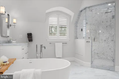 a bathroom with a bathtub and shower