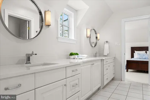 a spacious bedroom with a bed and a window