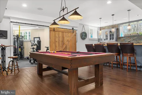 a kitchen with kitchen island granite countertop a table and chairs in it