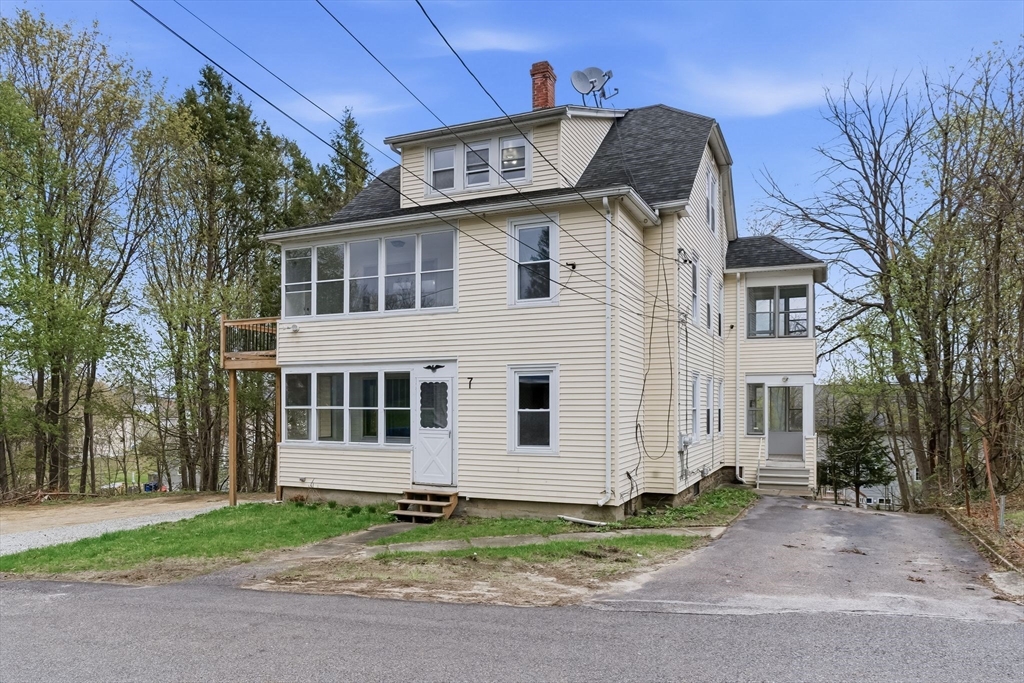 7 3rd Avenue Dudley, MA 01571 - Photo 1 of 42 a front view of a house with a garden