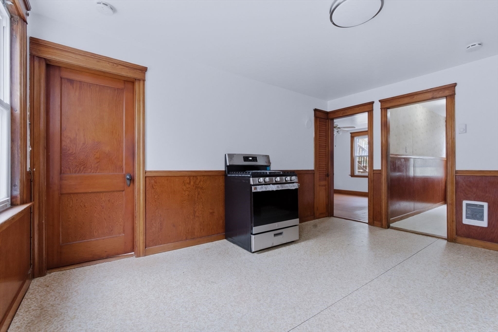 7 3rd Avenue Dudley, MA 01571 - Photo 2 of 42 a view of an empty room with a fireplace and a window