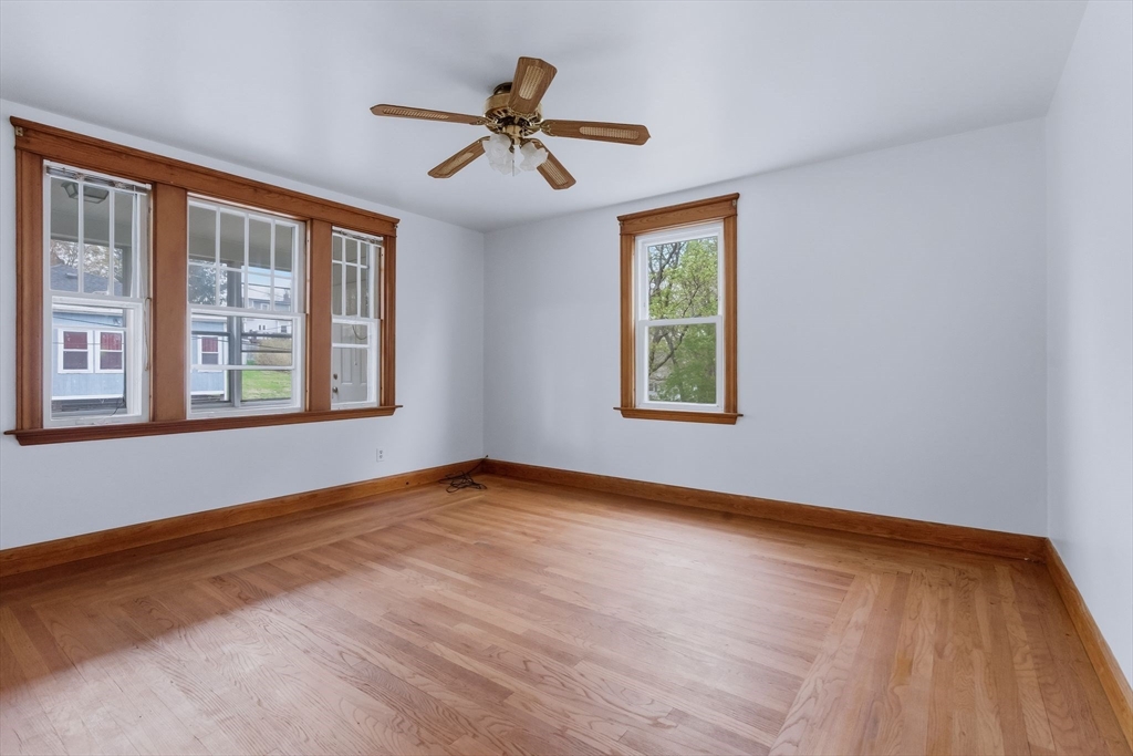 7 3rd Avenue Dudley, MA 01571 - Photo 21 of 42 a view of an empty room with a window and wooden floor