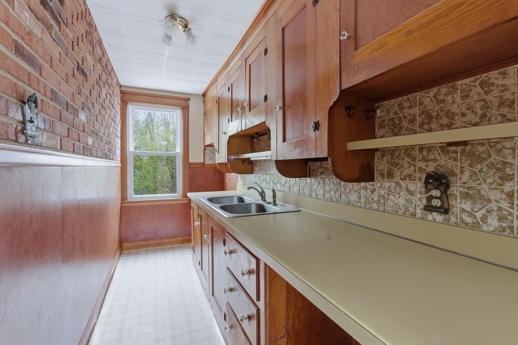 7 3rd Avenue Dudley, MA 01571 - Photo 25 of 42 a kitchen with a sink and a stove top oven