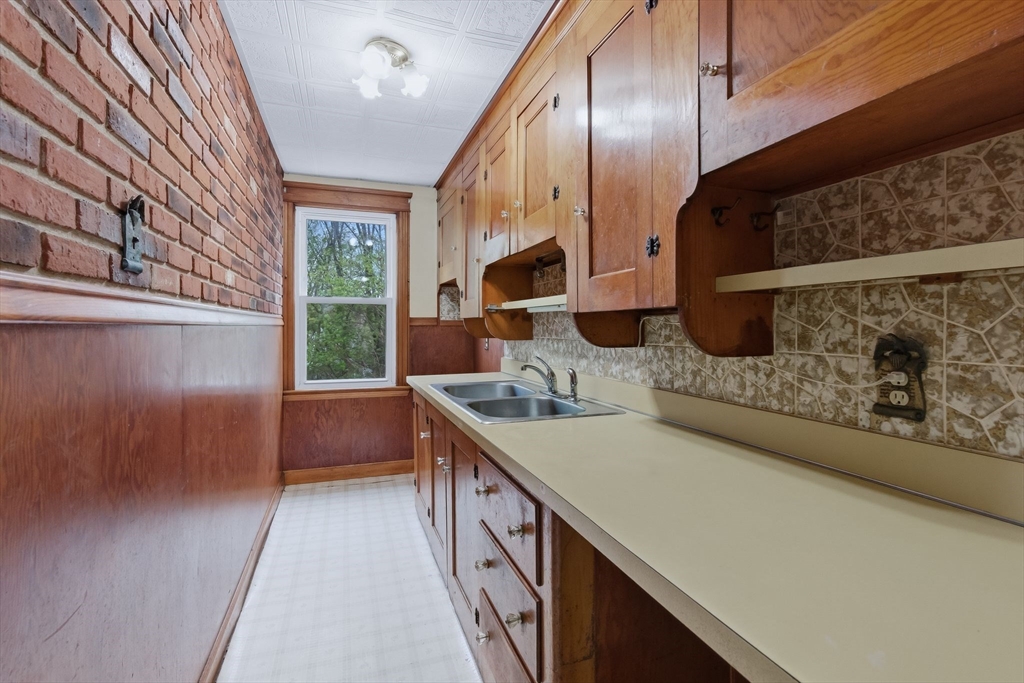 7 3rd Avenue Dudley, MA 01571 - Photo 26 of 42 a kitchen with stainless steel appliances granite countertop a sink a stove and a wooden floors