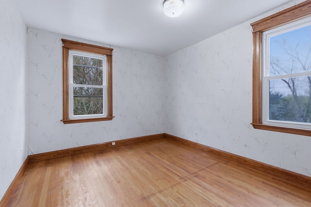7 3rd Avenue Dudley, MA 01571 - Photo 27 of 42 a view of an empty room with wooden floor and a window
