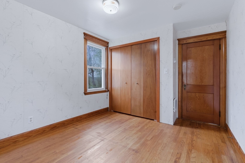 7 3rd Avenue Dudley, MA 01571 - Photo 28 of 42 an empty room with wooden floor and windows