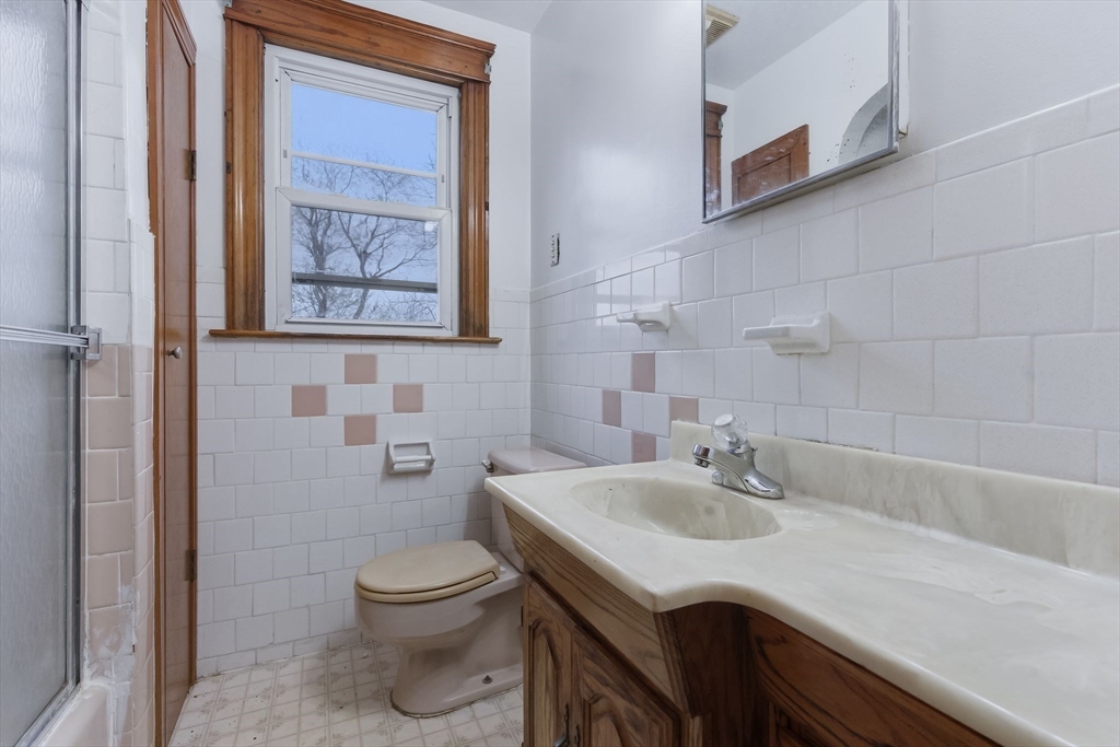 7 3rd Avenue Dudley, MA 01571 - Photo 29 of 42 a bathroom with a sink a toilet and shower