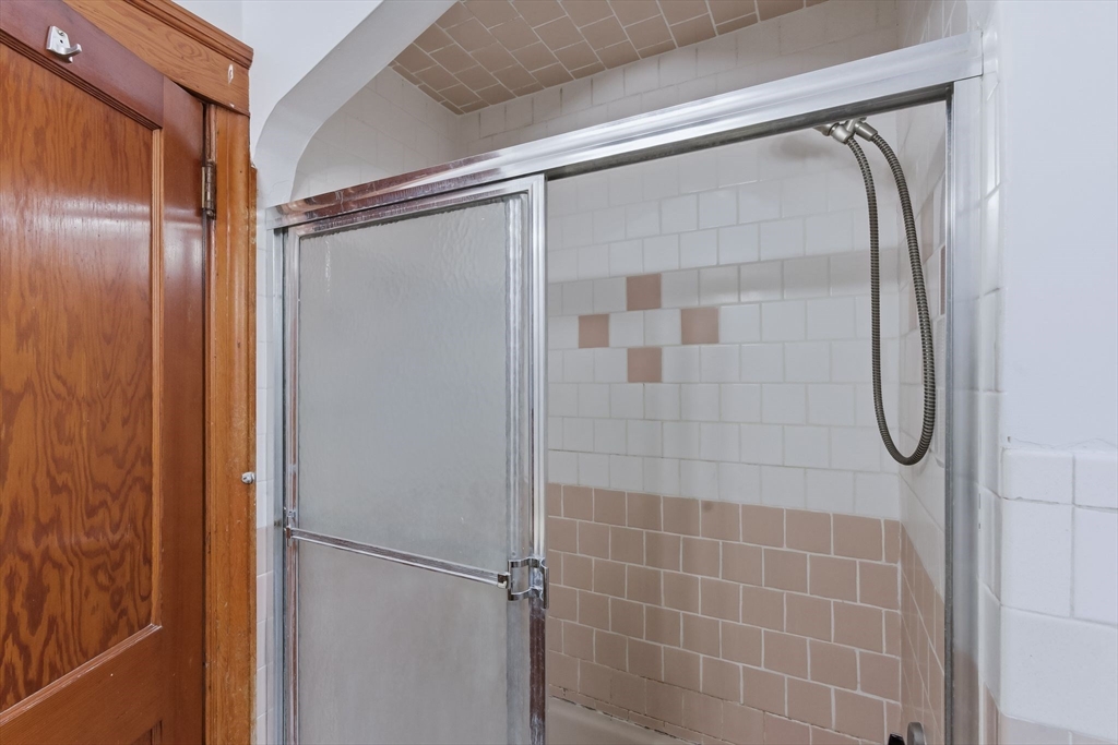 7 3rd Avenue Dudley, MA 01571 - Photo 31 of 42 a bathroom with a glass shower door