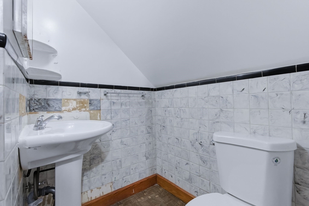 7 3rd Avenue Dudley, MA 01571 - Photo 32 of 42 a bathroom with a sink a toilet and mirror