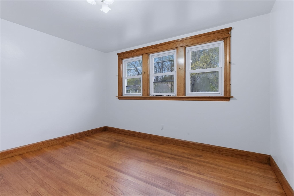 7 3rd Avenue Dudley, MA 01571 - Photo 34 of 42 a view of empty room with wooden floor and fan