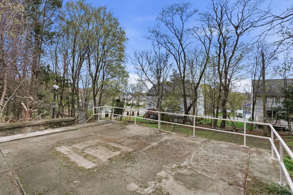 7 3rd Avenue Dudley, MA 01571 - Photo 35 of 42 a view of a yard with wooden fence and large trees