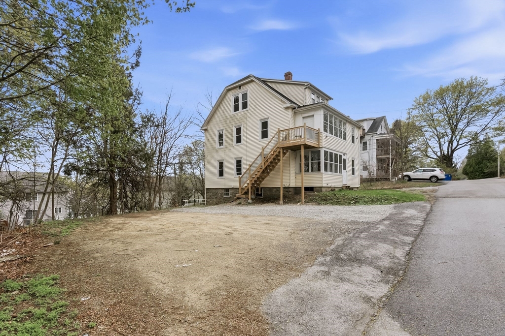 7 3rd Avenue Dudley, MA 01571 - Photo 38 of 42 a large white house with a large tree in front of it