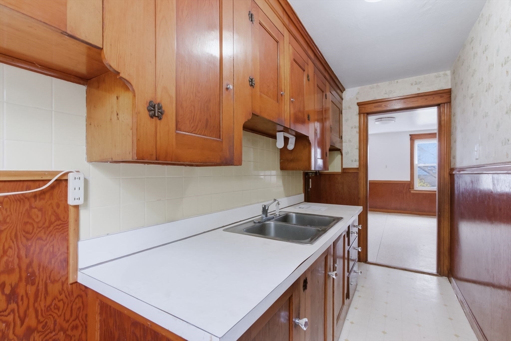 7 3rd Avenue Dudley, MA 01571 - Photo 5 of 42 a kitchen with stainless steel appliances granite countertop a sink a stove and a refrigerator with wooden floor